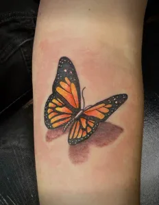 A tattoo of a monarch butterfly on the arm by Legendary Tattoos in Las Vegas, Nevada.