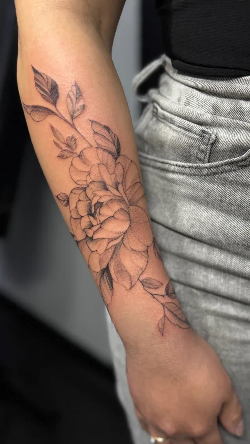 Forearm tattoo featuring black and grey floral fine line art on a client’s arm, done at Legendary Tattoos in Las Vegas. Clean, detailed, and professional ink work.
