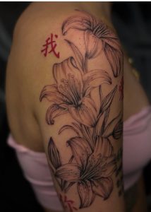 Shoulder tattoo and start of sleeve featuring flowers