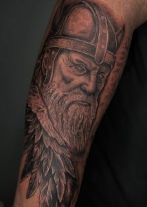 A tattoo of a warrior with a medieval helmet by Brian Hlavac in Las Vegas at Legendary Tattoos.