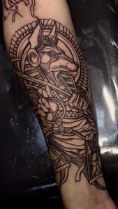 A black ink tattoo by Legendary artist Jose Mundo featuring an Egyptian-style dog