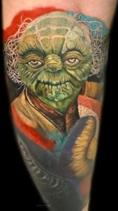 A color ink tattoo of Yoda