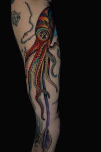 A color ink tattoo of a large squid