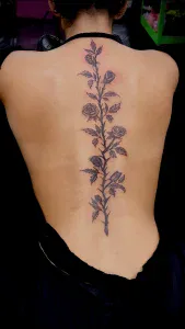 Roses on women's spine on her back. This tattoo was done by Legendary Tattoos in Las Vegas Nevada.