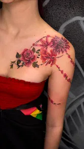 A woman with a tattoo of flowers on her shoulder by Legendary Tattoos in Las Vegas Nevada.