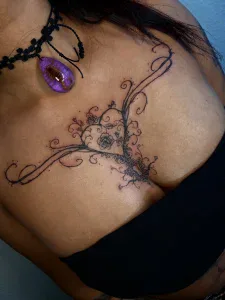 Chest butterfly and ornamental fine line tattoo at Legendary Tattoos in Las Vegas, Nevada