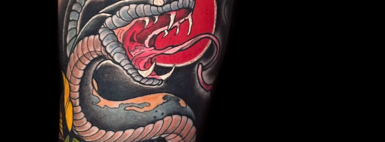 Neotraditional snake tattoo by Legendary Tattoos. Neotradtional Tattoo of a fierce snake by Legendary Tattoos in Las Vegas.