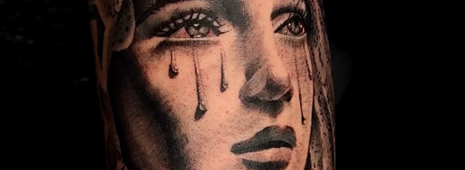 Mother Mary crying black and grey realism tattoos by Legendary Tattoos in Las Vegas.