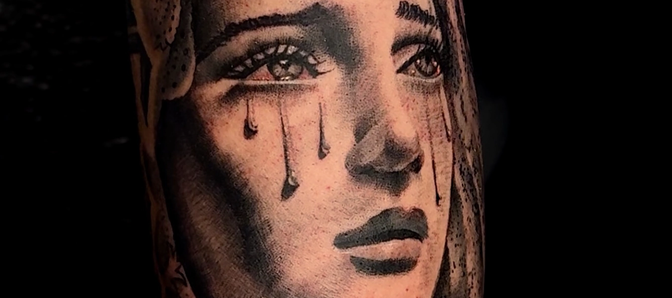 Mother Mary crying black and grey realism tattoos by Legendary Tattoos in Las Vegas.