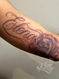 Script lettering “Elenor” in red ink tattoo on forearm at Legendary Tattoos in Las Vegas, Nevada