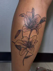 Lily flower tattoo on calf/leg at Legendary Tattoos in Las Vegas, Nevada
